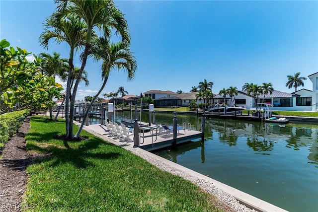931 Snowberry Ct, Marco Island, FL 34145 - view of dock with a yard, a water view, a residential view, and boat lift