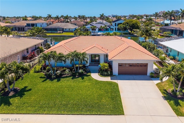 931 Snowberry Ct, Marco Island, FL 34145 - view of front facade with a tile roof, a residential view, concrete driveway, an attached garage, and stucco siding