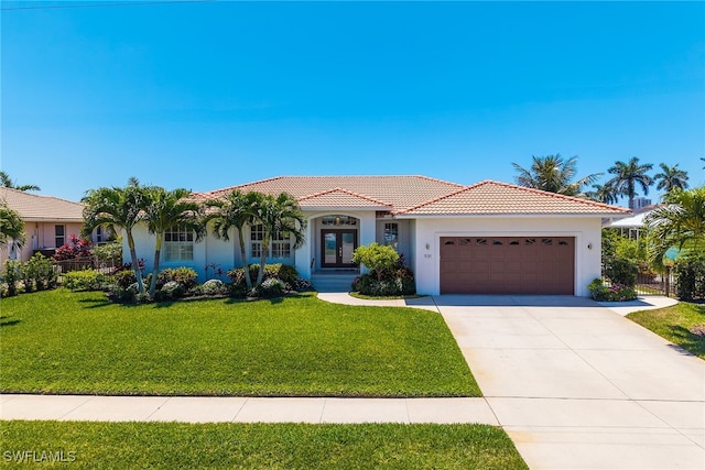 931 Snowberry Ct, Marco Island, FL 34145 - mediterranean / spanish house with driveway, a tile roof, a front yard, a garage, and stucco siding