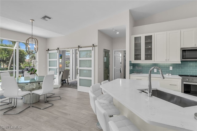 931 Snowberry Ct, Marco Island, FL 34145 - kitchen featuring a sink, light wood-style flooring, a healthy amount of sunlight, and stainless steel appliances
