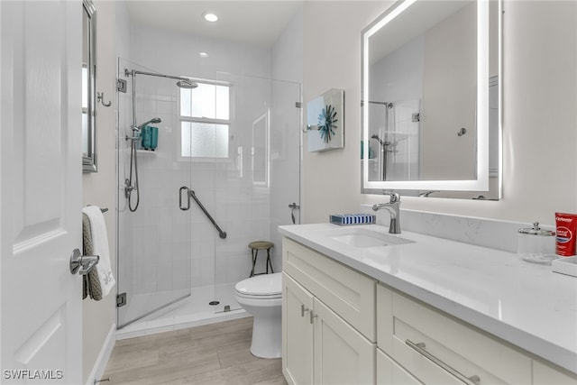 931 Snowberry Ct, Marco Island, FL 34145 - bathroom featuring vanity, toilet, wood finished floors, and a stall shower