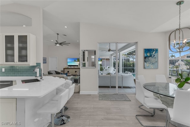 931 Snowberry Ct, Marco Island, FL 34145 - dining space with light wood-type flooring, recessed lighting, ceiling fan with notable chandelier, and high vaulted ceiling