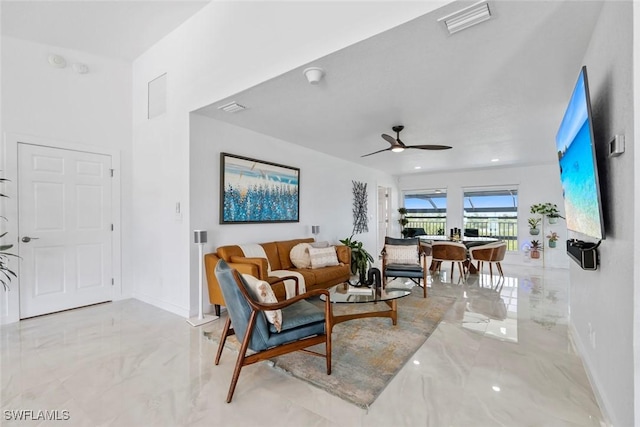 living area featuring baseboards, marble finish floor, and visible vents