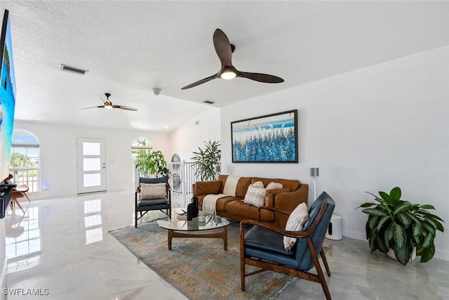 living room featuring visible vents, marble finish floor, ceiling fan, and lofted ceiling