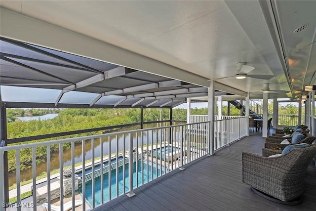 wooden deck featuring a ceiling fan and an outdoor pool
