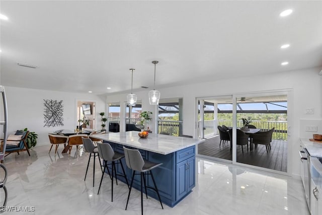 kitchen with recessed lighting, a kitchen breakfast bar, blue cabinetry, and marble finish floor