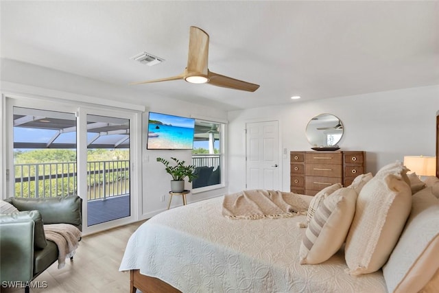 bedroom featuring visible vents, access to exterior, multiple windows, and light wood-style floors