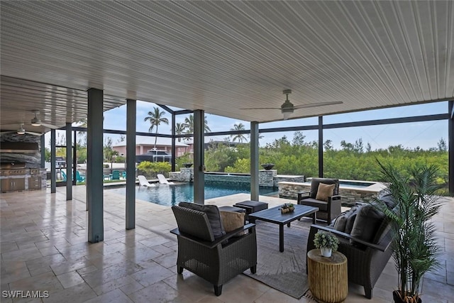 view of patio / terrace with ceiling fan, an in ground hot tub, an outdoor pool, an outdoor kitchen, and outdoor lounge area