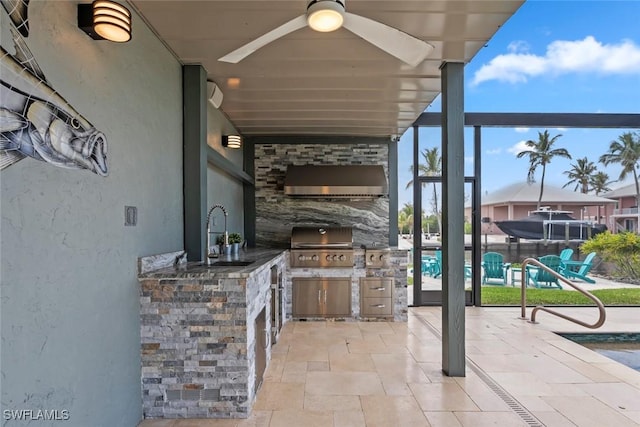 view of patio / terrace with ceiling fan, a sink, a grill, and an outdoor kitchen