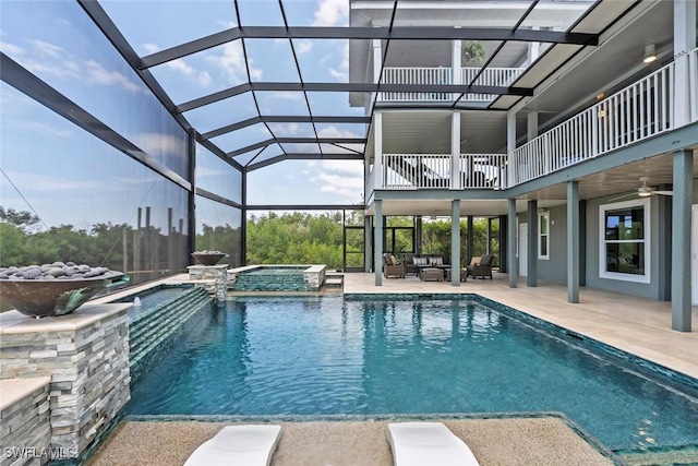 view of swimming pool with a lanai, a ceiling fan, a pool with connected hot tub, a patio area, and outdoor lounge area