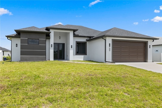 prairie-style house with concrete driveway, stucco siding, an attached garage, and a front yard