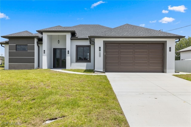 prairie-style house with an attached garage, stucco siding, concrete driveway, and a front yard