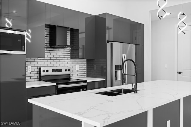kitchen featuring stainless steel appliances, gray cabinetry, modern cabinets, and wall chimney exhaust hood