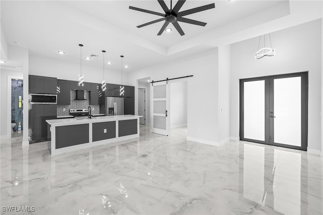 kitchen featuring appliances with stainless steel finishes, a barn door, light countertops, recessed lighting, and modern cabinets