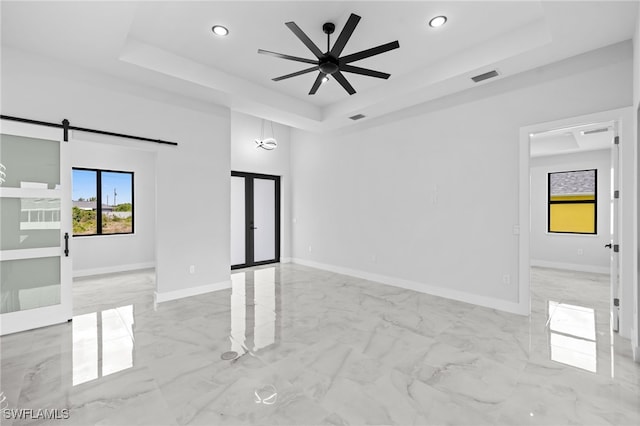 unfurnished room featuring visible vents, recessed lighting, marble finish floor, and a tray ceiling
