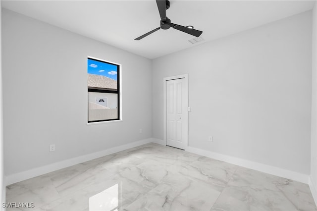empty room featuring baseboards and marble finish floor