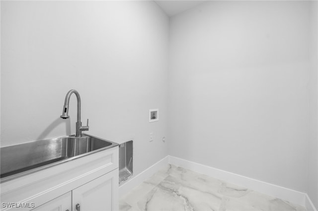 clothes washing area with cabinet space, washer hookup, a sink, marble finish floor, and baseboards