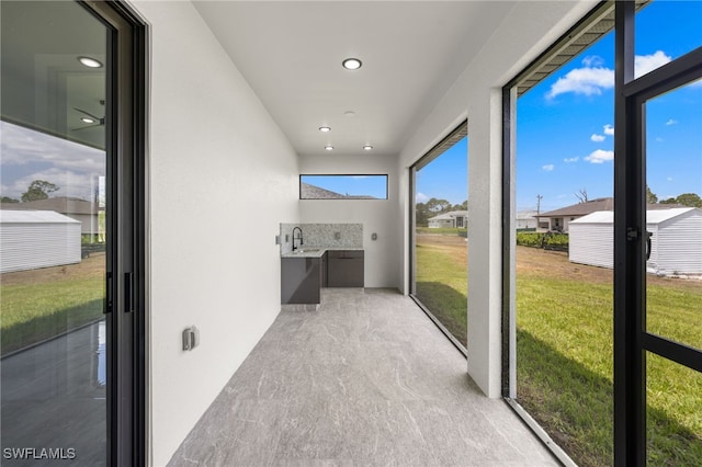 unfurnished sunroom featuring a sink