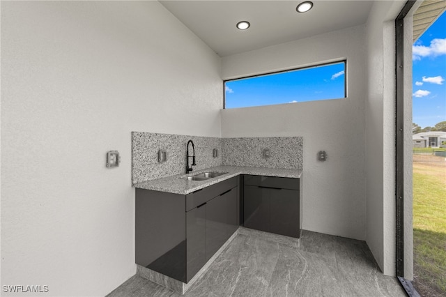 bathroom featuring recessed lighting, plenty of natural light, and a sink