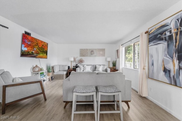 bedroom with wood finished floors and baseboards
