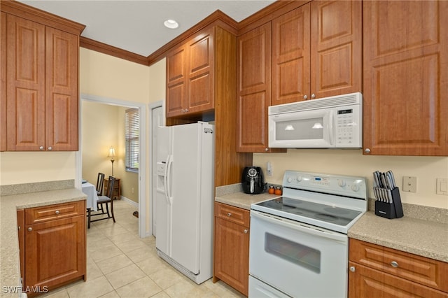 kitchen featuring light tile patterned flooring, white appliances, recessed lighting, light countertops, and brown cabinets