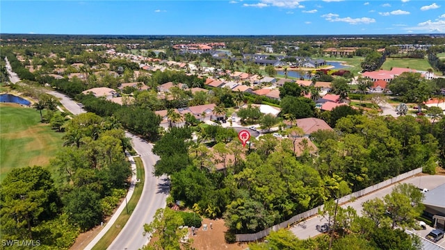 drone / aerial view with a water view, view of golf course, and a residential view