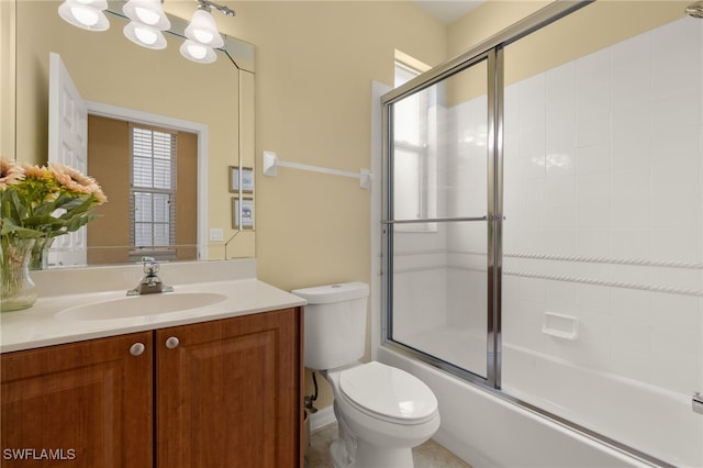 bathroom with vanity, combined bath / shower with glass door, and toilet
