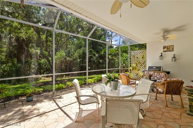sunroom / solarium with ceiling fan and outdoor dining area