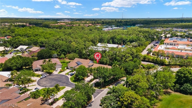 birds eye view of property with a residential view and a wooded view