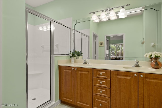 full bath with double vanity, a sink, and a stall shower