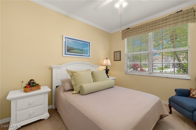 carpeted bedroom featuring crown molding, a ceiling fan, and baseboards