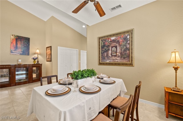 dining area with visible vents, light tile patterned flooring, baseboards, ceiling fan, and high vaulted ceiling