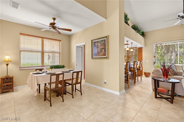 dining space with baseboards, ceiling fan, visible vents, and a healthy amount of sunlight