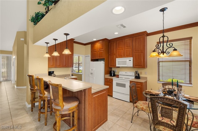 kitchen featuring white appliances, light countertops, a peninsula, light tile patterned floors, and visible vents