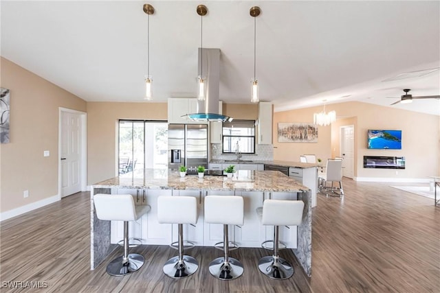 919 SE 16th St, Cape Coral, FL 33990 - kitchen with stainless steel refrigerator with ice dispenser, a sink, lofted ceiling, a kitchen island, and dark wood finished floors
