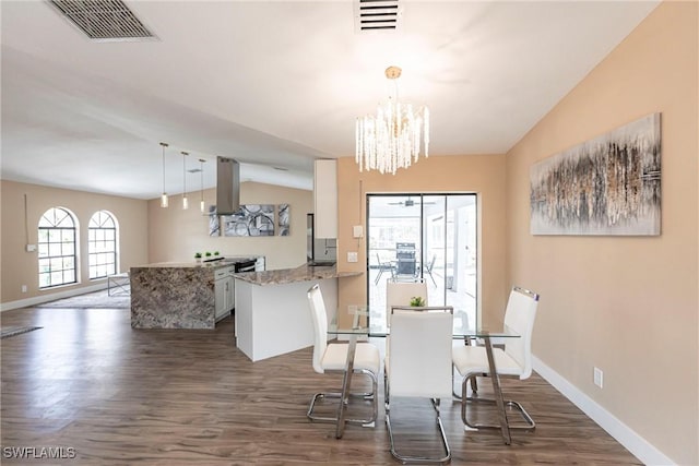 919 SE 16th St, Cape Coral, FL 33990 - dining space with vaulted ceiling, dark wood-style flooring, baseboards, and a chandelier