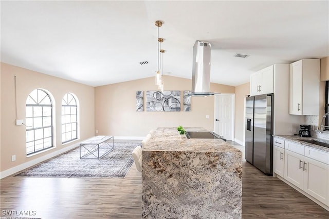 919 SE 16th St, Cape Coral, FL 33990 - kitchen with stainless steel fridge with ice dispenser, island exhaust hood, vaulted ceiling, dark wood-style flooring, and white cabinetry
