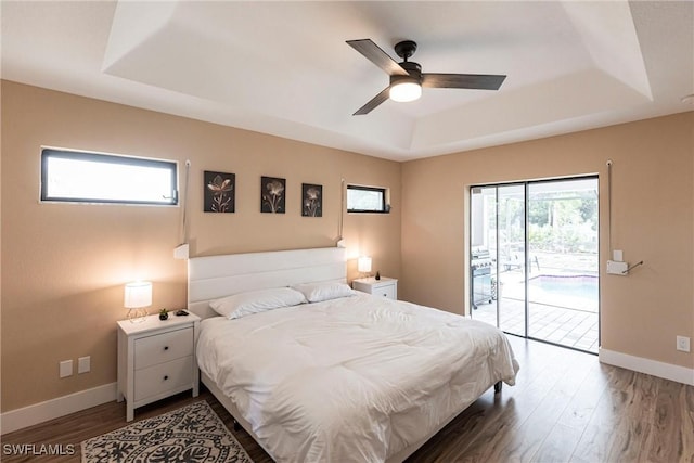 919 SE 16th St, Cape Coral, FL 33990 - bedroom featuring a raised ceiling, access to exterior, wood finished floors, and ceiling fan