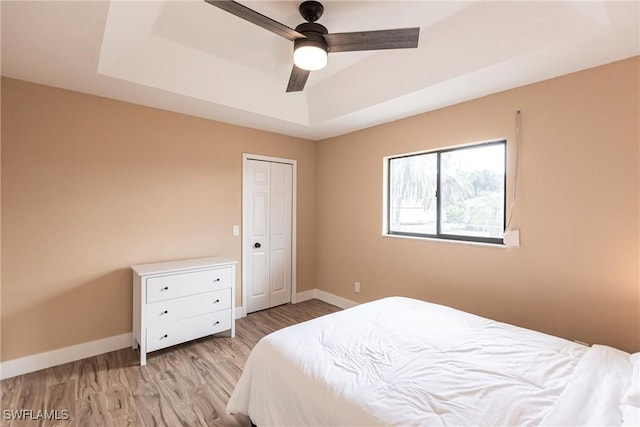 919 SE 16th St, Cape Coral, FL 33990 - bedroom with a tray ceiling, wood finished floors, a ceiling fan, and a closet