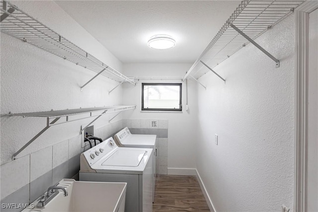 919 SE 16th St, Cape Coral, FL 33990 - laundry room featuring washer and dryer, a textured wall, dark wood-style floors, and baseboards