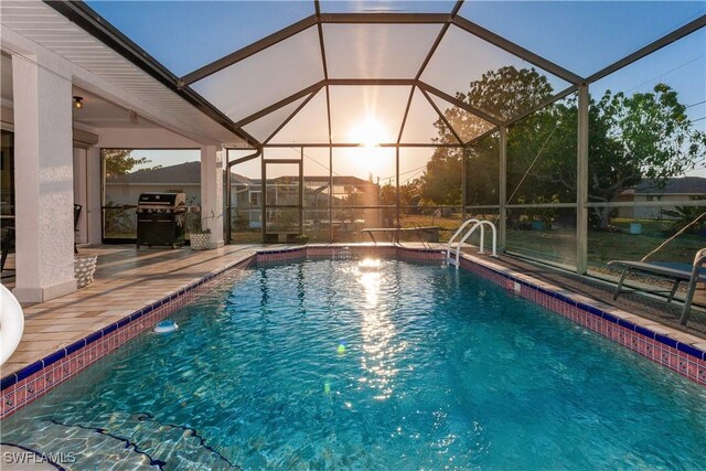 919 SE 16th St, Cape Coral, FL 33990 - outdoor pool with area for grilling, a patio area, and glass enclosure
