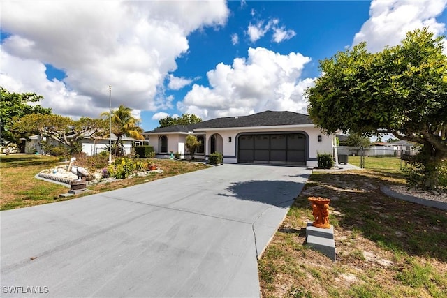 919 SE 16th St, Cape Coral, FL 33990 - ranch-style house featuring a garage, stucco siding, and driveway
