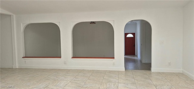 315 Cleveland Ave, Lehigh Acres, FL 33936 - empty room with arched walkways and baseboards
