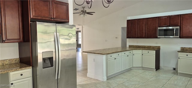 315 Cleveland Ave, Lehigh Acres, FL 33936 - kitchen featuring a peninsula, dark stone counters, a ceiling fan, vaulted ceiling, and stainless steel appliances