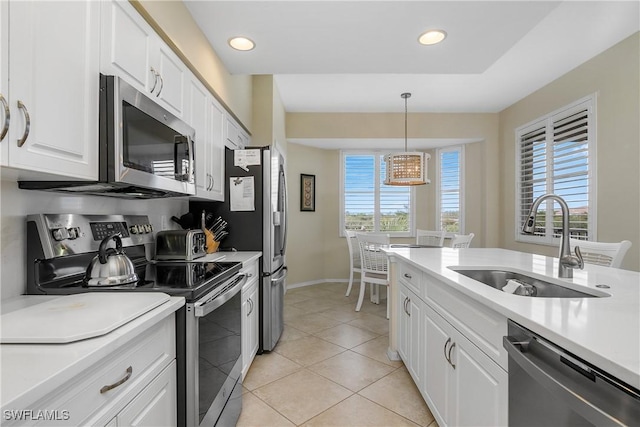 7505 Stoneybrook Dr Unit 746, Naples, FL 34112 - kitchen with white cabinets, baseboards, appliances with stainless steel finishes, and a sink
