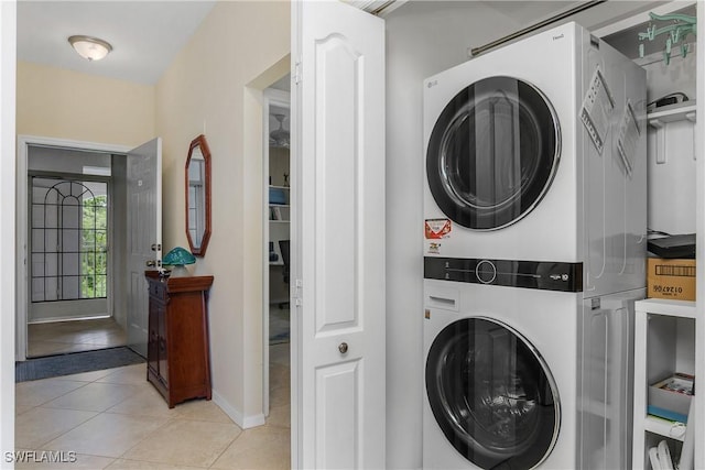 7505 Stoneybrook Dr Unit 746, Naples, FL 34112 - laundry room featuring laundry area, stacked washer and clothes dryer, baseboards, and light tile patterned floors