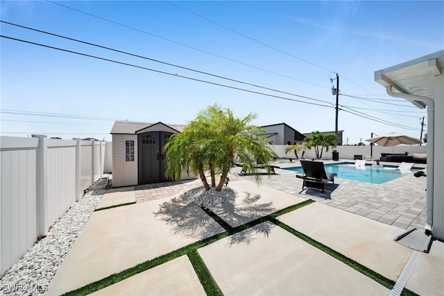 202 NE 16th Ter, Cape Coral, FL 33909 - view of patio / terrace featuring a storage unit, a fenced backyard, an outbuilding, and a fenced in pool