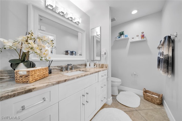 202 NE 16th Ter, Cape Coral, FL 33909 - bathroom with vanity, baseboards, tile patterned flooring, and toilet