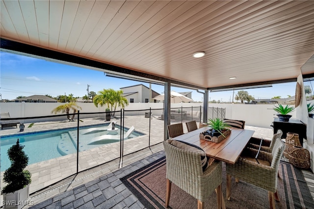 202 NE 16th Ter, Cape Coral, FL 33909 - exterior space featuring a fenced backyard, a fenced in pool, a jacuzzi, and outdoor dining space