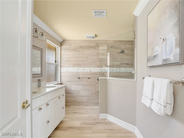 11526 Forest Mere Dr, Bonita Springs, FL 34135 - bathroom featuring walk in shower, vanity, crown molding, and visible vents